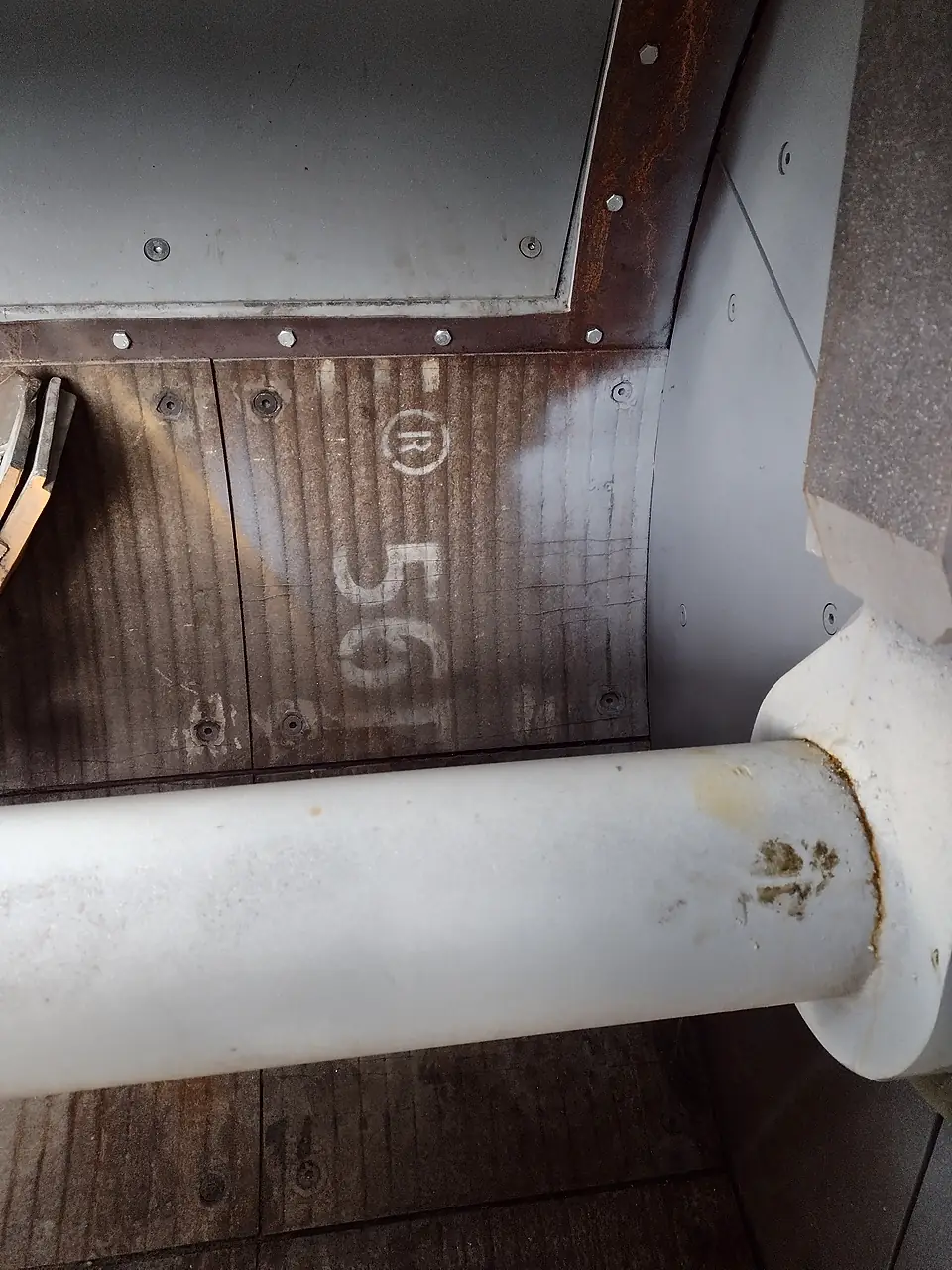 Mixing arm and wear liners inside a concrete mixer