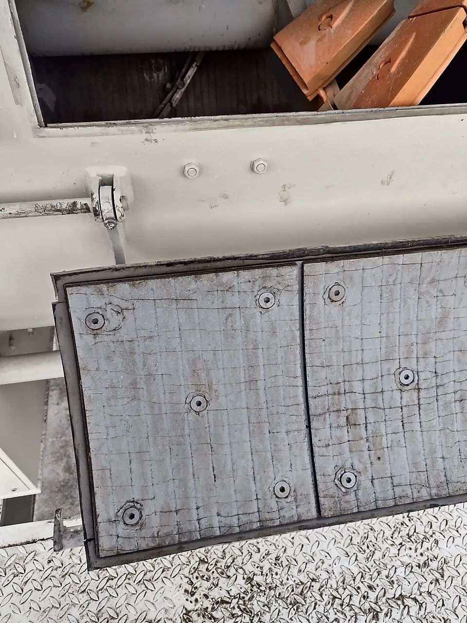 Bolted inspection hatch on a concrete mixer