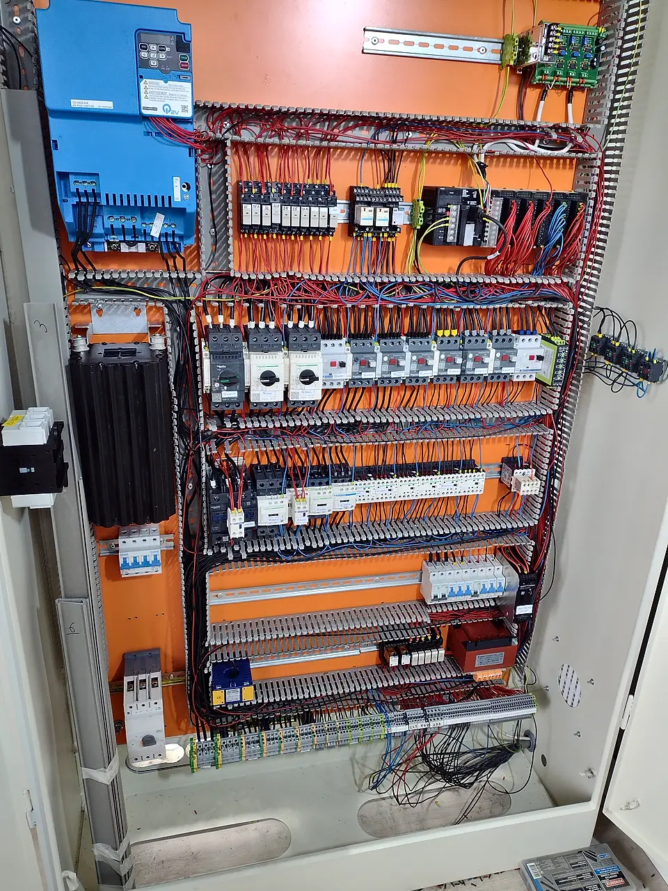 Control cabinet with inverter, circuit breakers and terminal rows