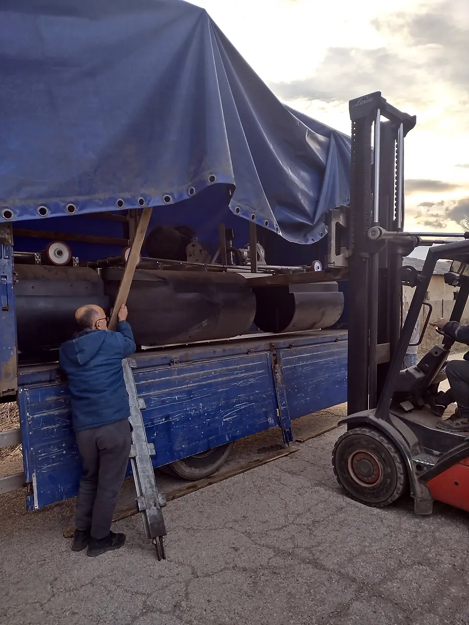 Forklift loading a pontoon onto a truck