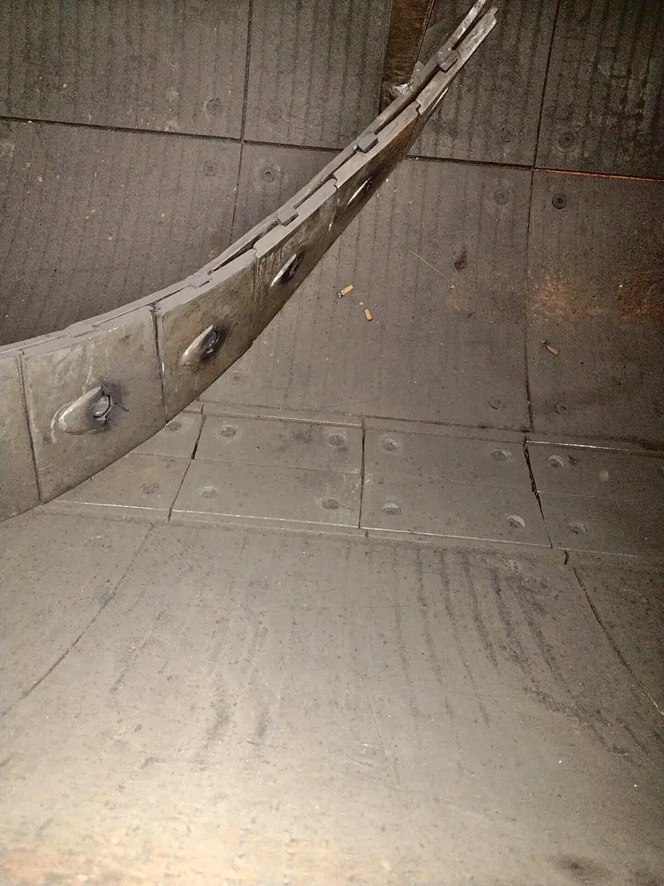 Mixer floor tiles and a curved liner strip
