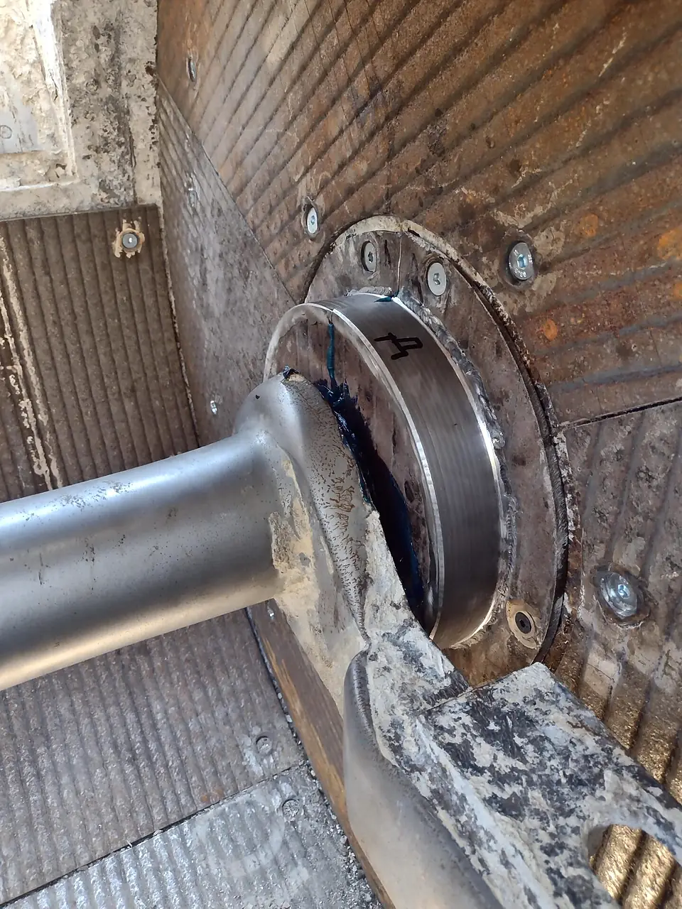 Shaft seal housing and overlay wear plates inside a mixer